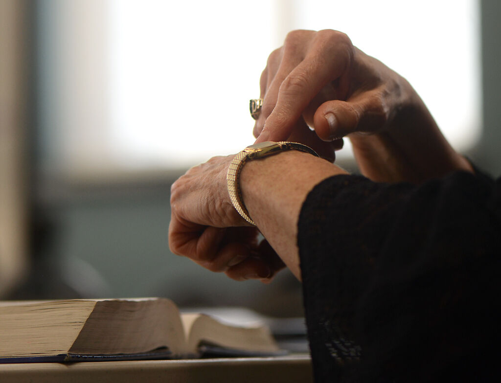 Eunice Morrow signs "time" while signing with members of the deaf community